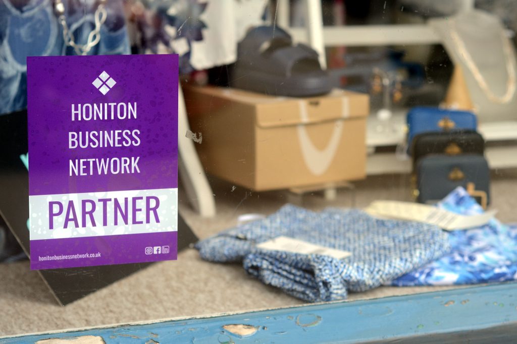 The Coastal Boutique shop window with a HBN window sticker