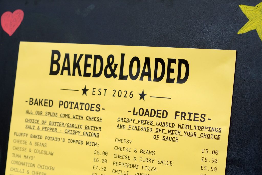 Baked & Loaded sign board advertising baked potatoes and loaded fries